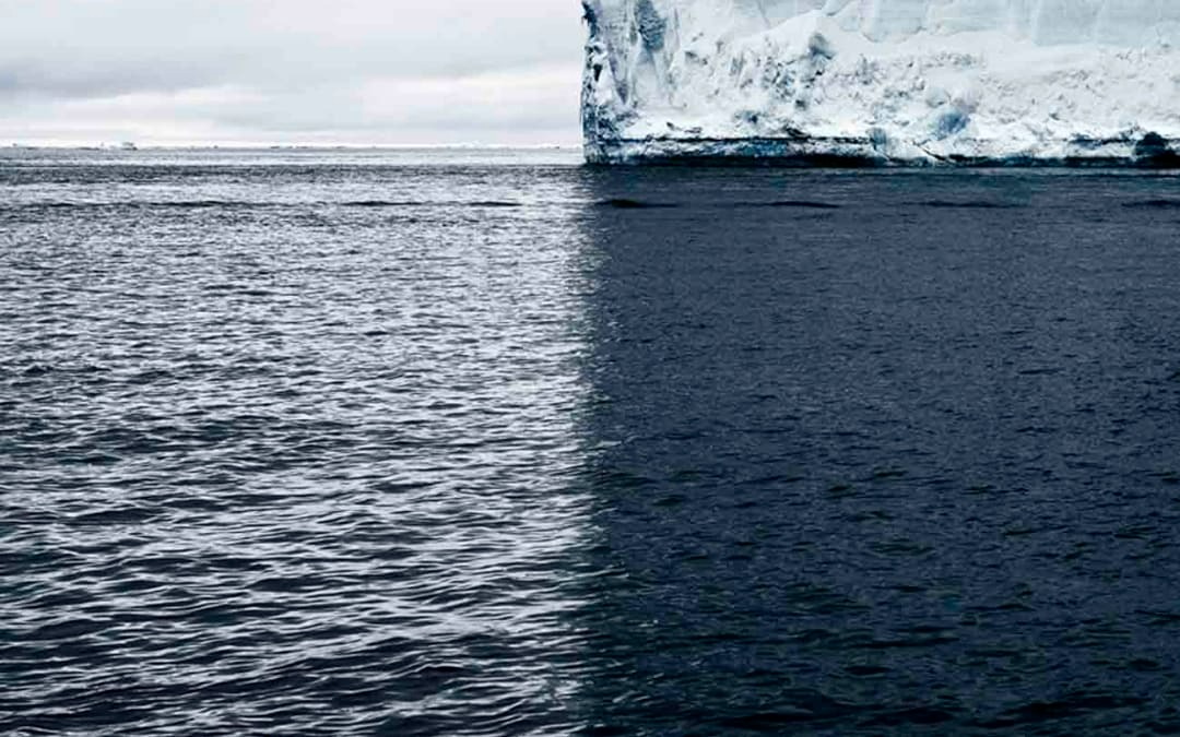 Nature's Canvas: A Towering Iceberg and Its Shadow Divide the World ...